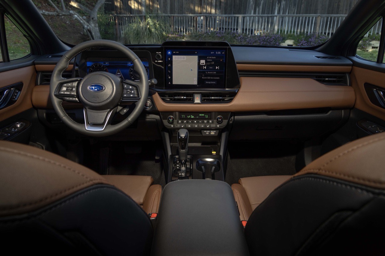 The Subaru Outback dashboard seen head-on, with the center touchscreen and tan leather seats either side
